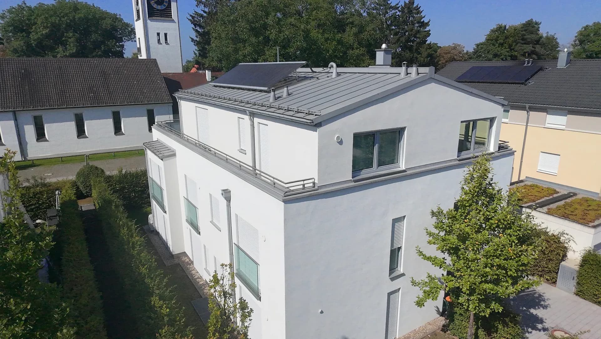Modernes Mehrfamilienhaus mit gereinigtem Blechdach und Solaranlage