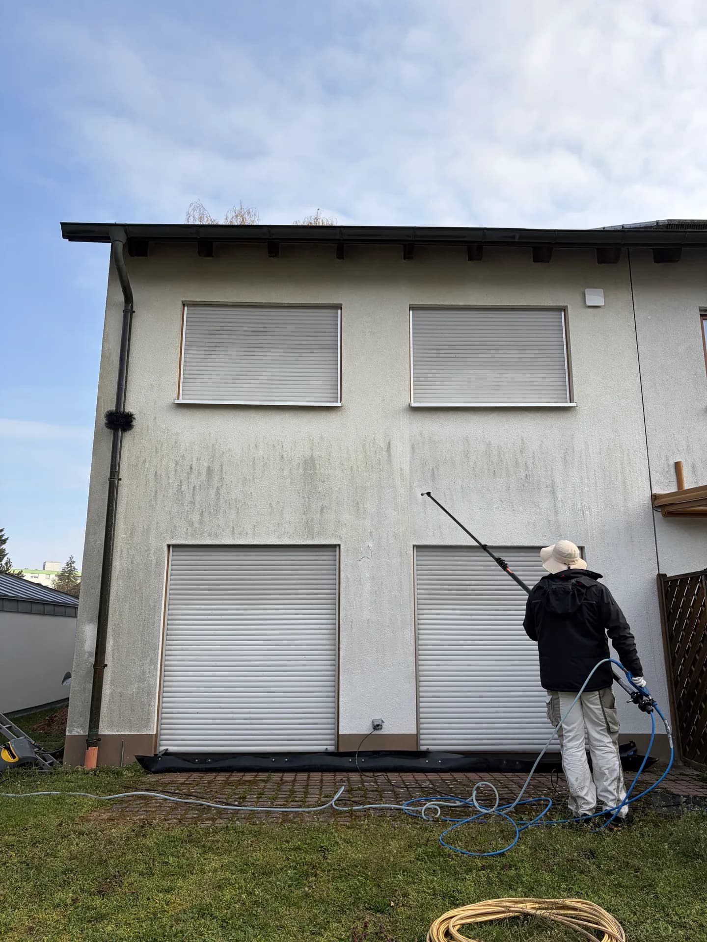 Mitarbeiter behandelt eine Giebelwand vor – Einsatzgebiet Baiersdorf